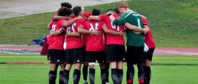 soccer team in a huddle